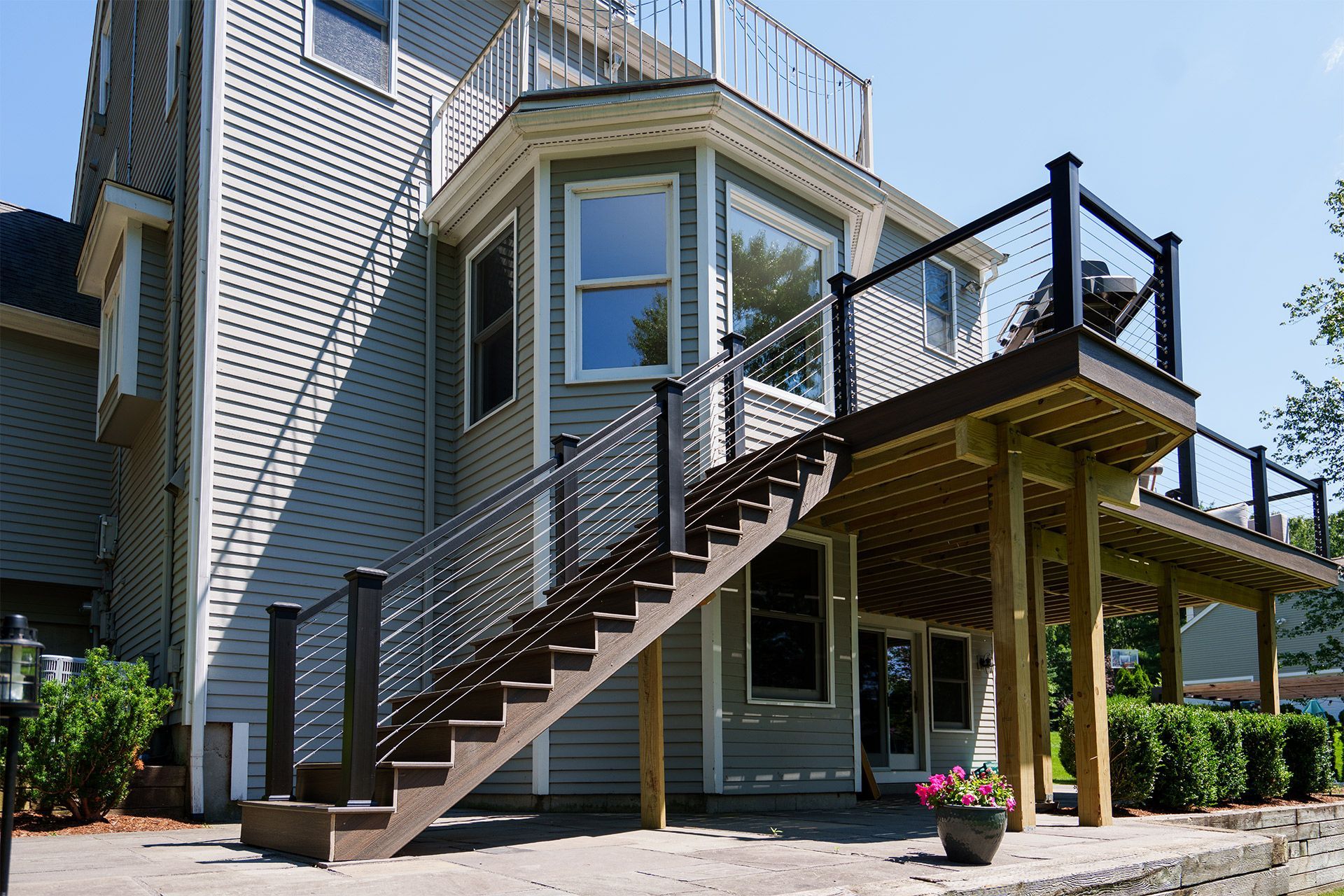 A house with a deck and stairs leading up to it.