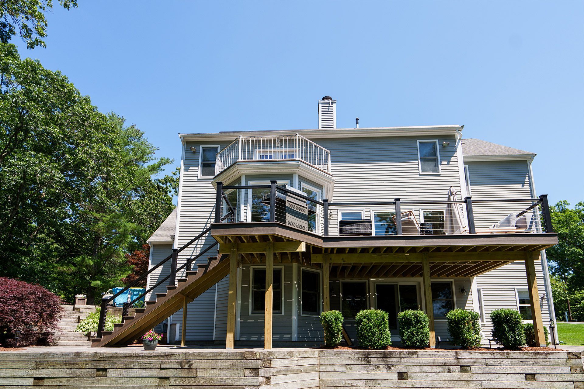 The back of a house with a large deck and stairs