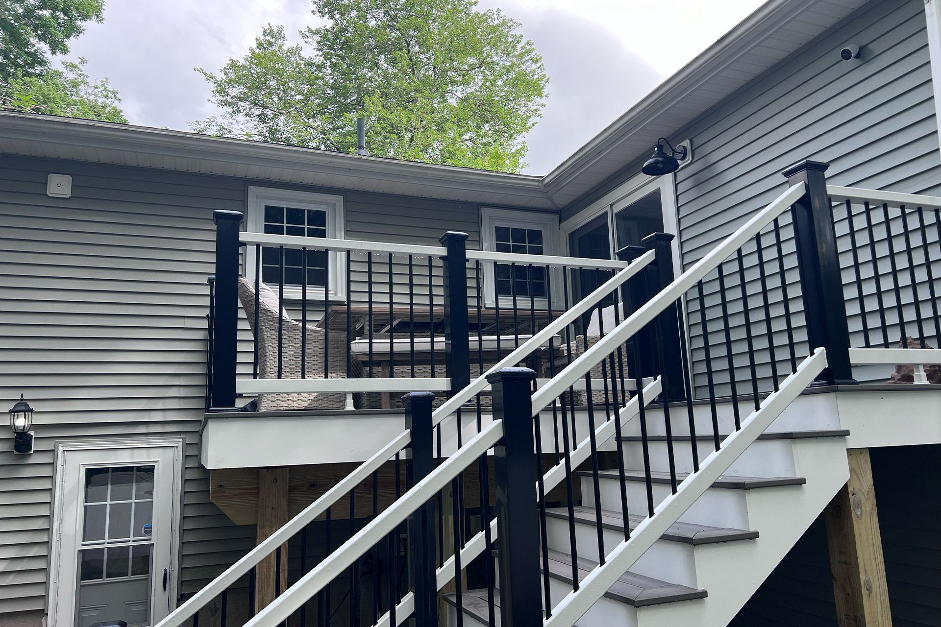 A house with a deck and stairs leading up to it.