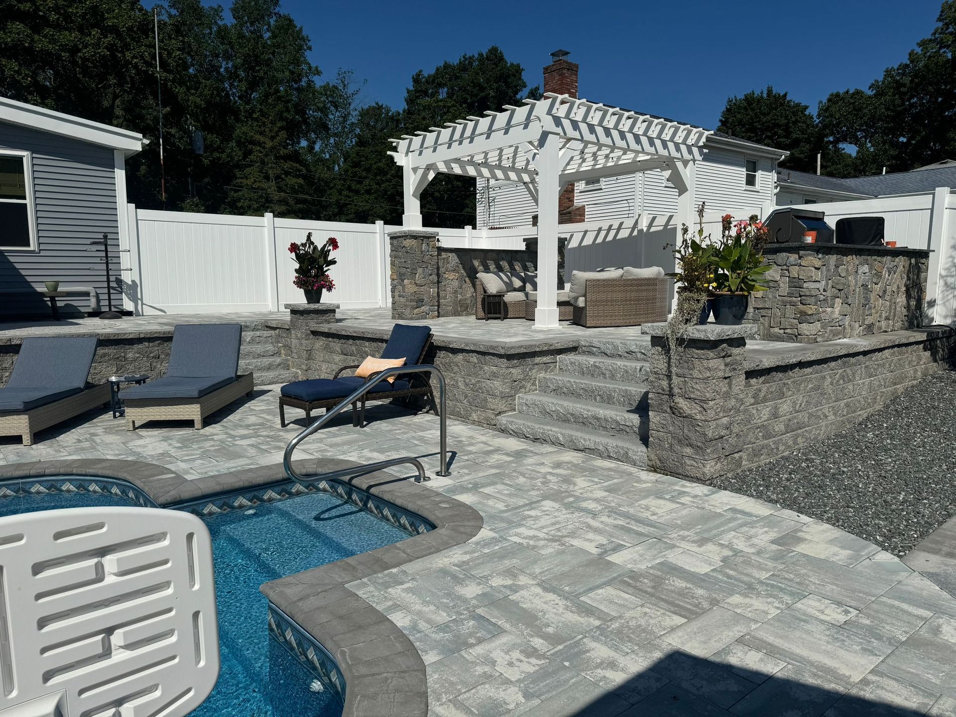 A patio area with a swimming pool and chairs