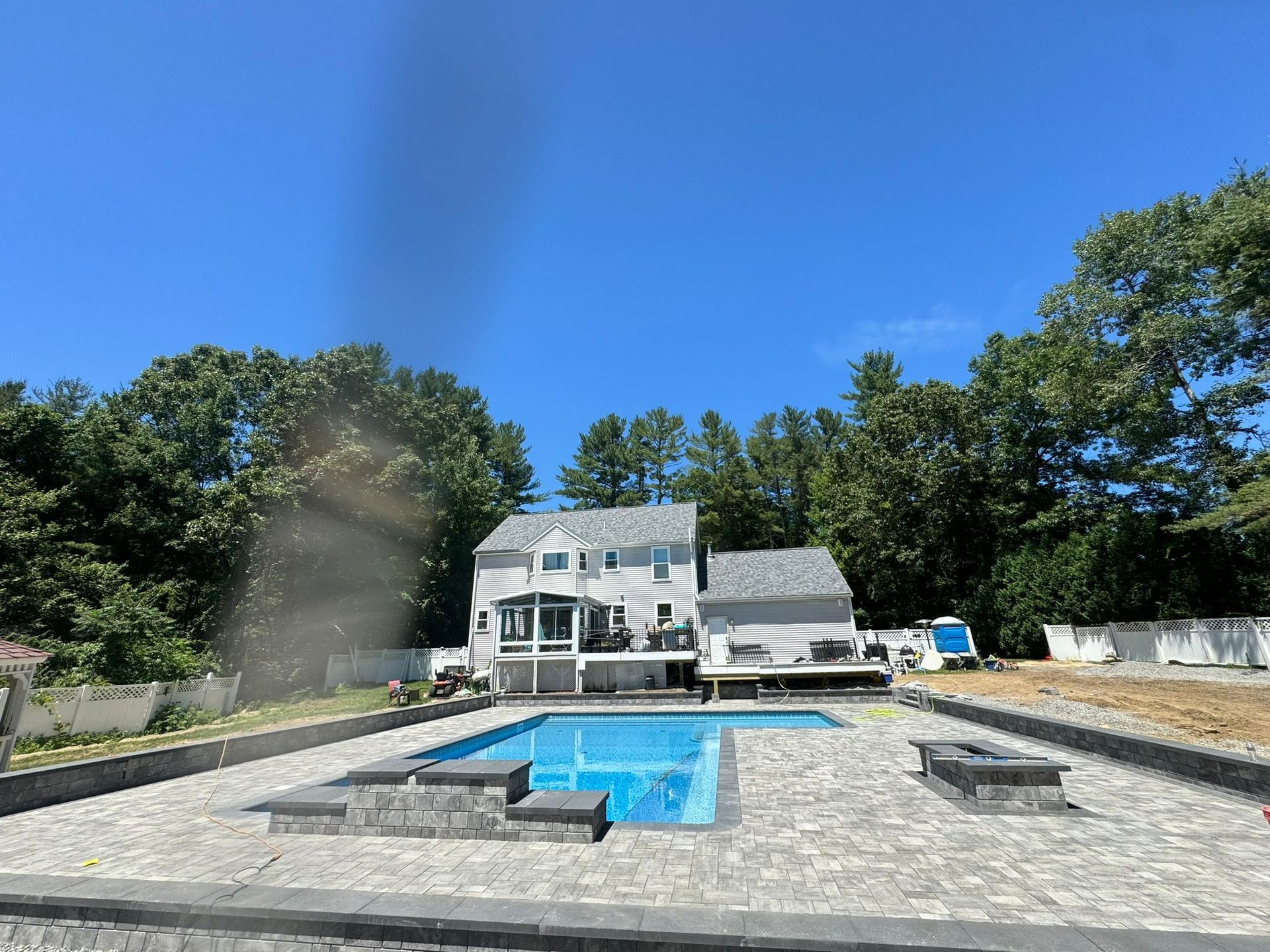 A large house with a swimming pool in front of it.