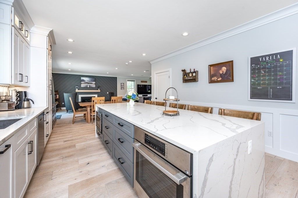 A kitchen with a large island and stainless steel appliances.