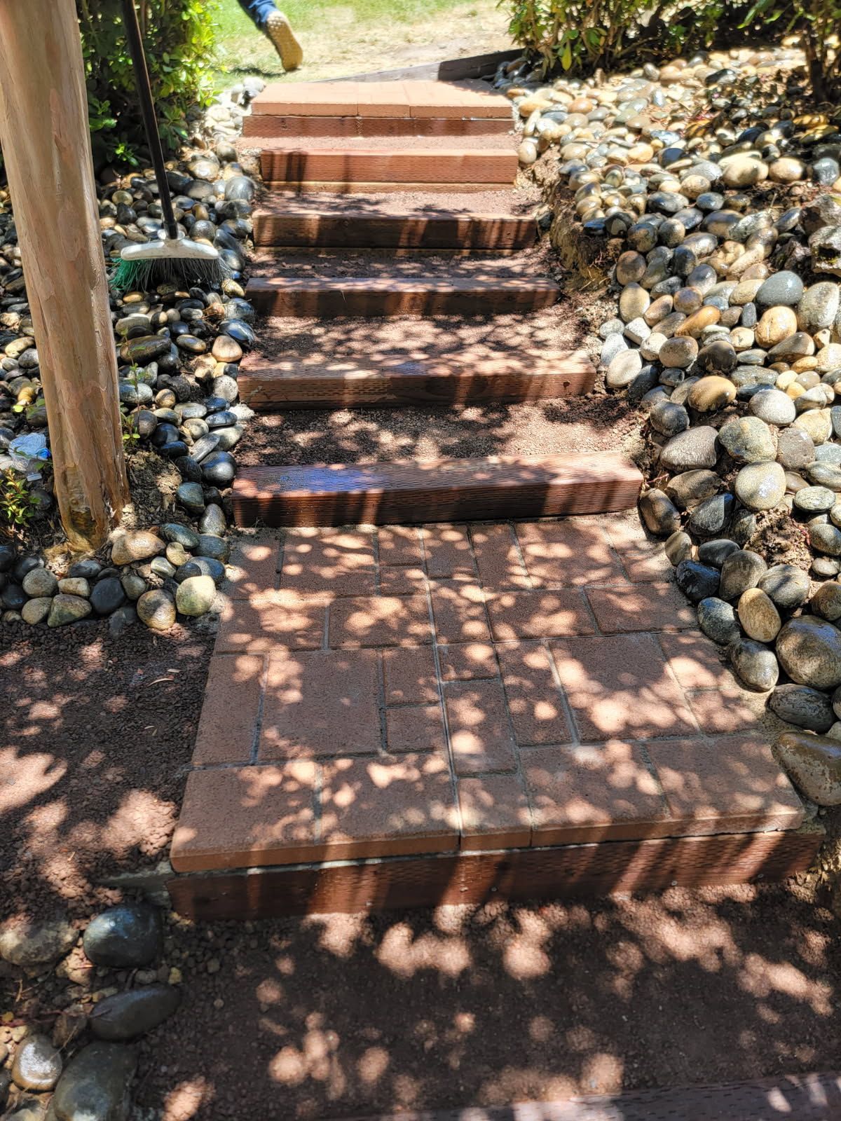 A set of brick stairs leading up to a rocky hillside