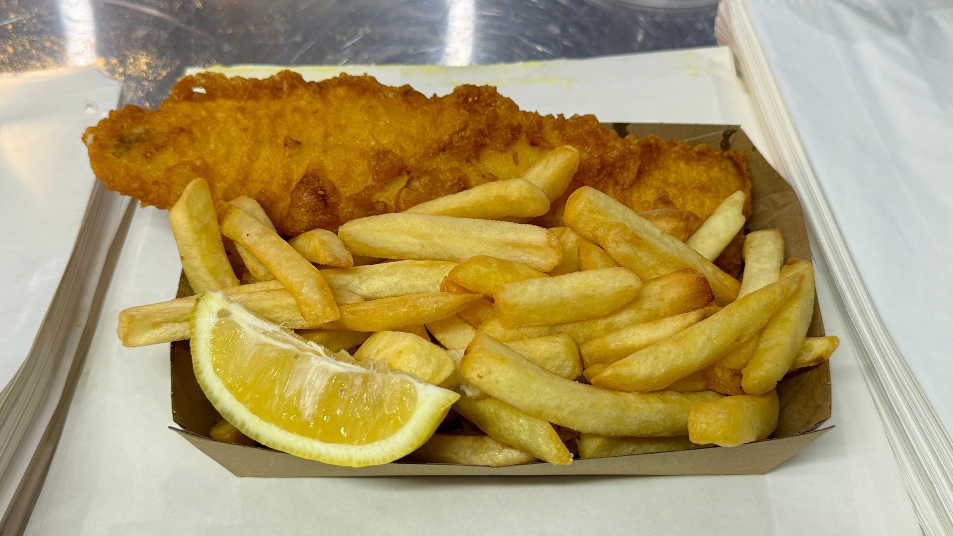 Fish and Chips With Sauce on a Table — Aussie Fish & Chips Nelson Bay in Nelson Bay, NSW
