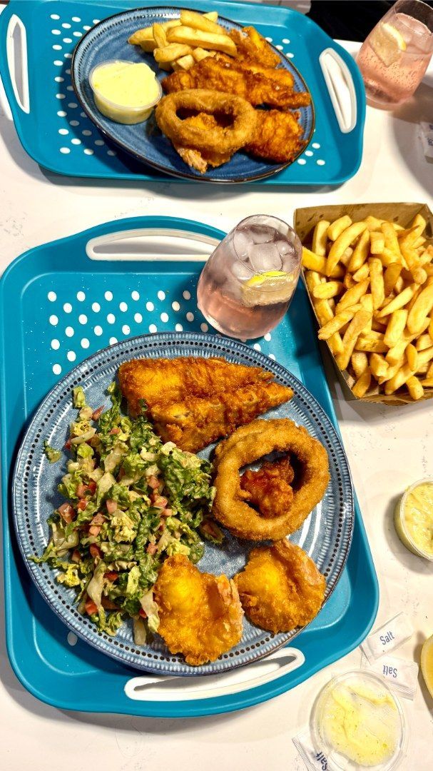 Two Plates of Fried Food, Including Fish, Onion Rings, and Fries — Aussie Fish & Chips Nelson Bay in Nelson Bay, NSW