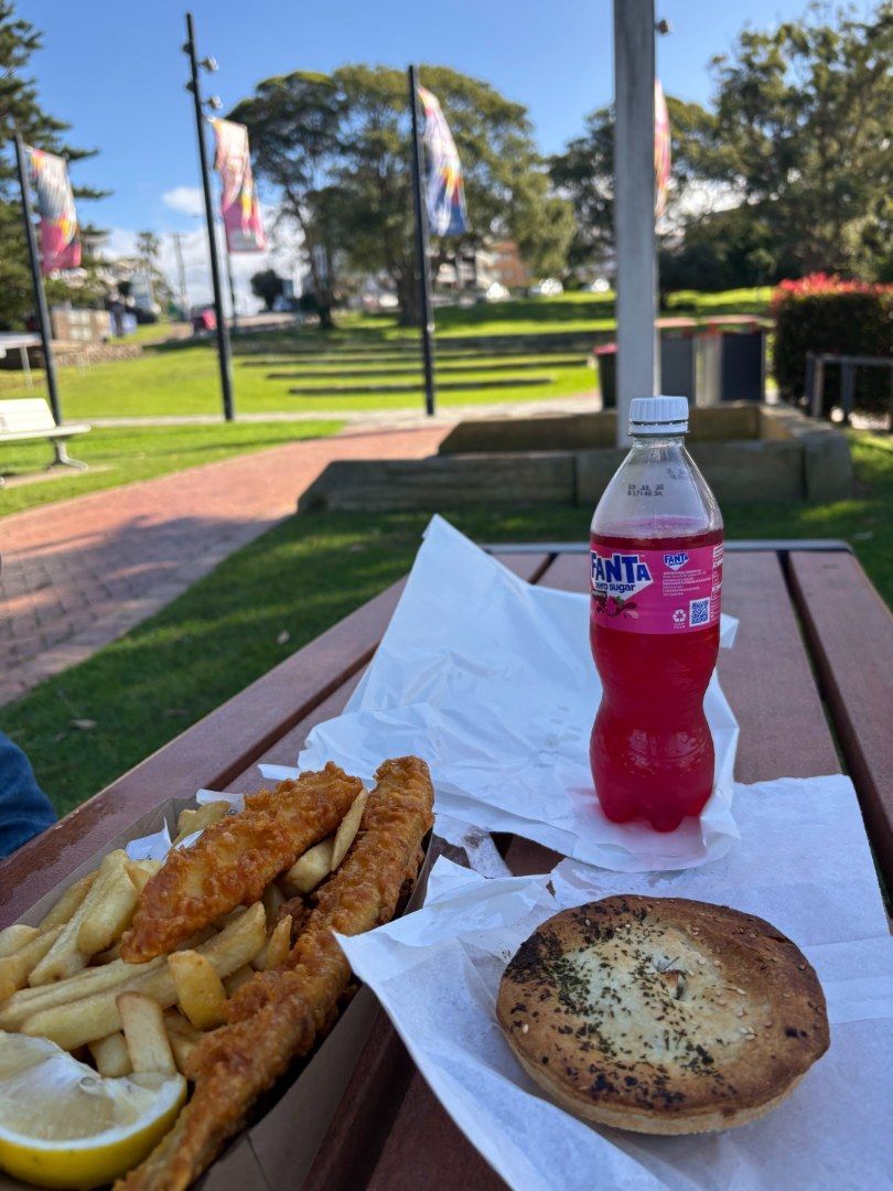 Fish and Chips, and Pink Drink on a Picnic Table Outdoors — Aussie Fish & Chips Nelson Bay in Nelson Bay, NSW