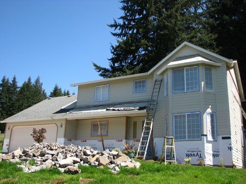 A large house with a ladder in front of it