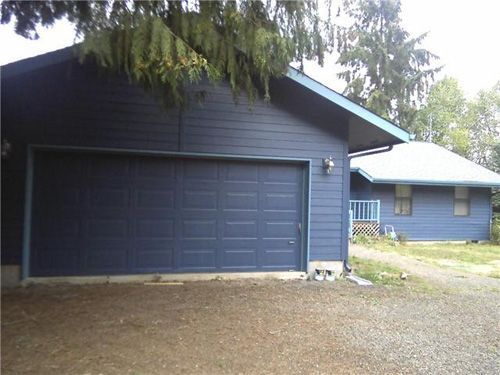 A blue house with a large garage door