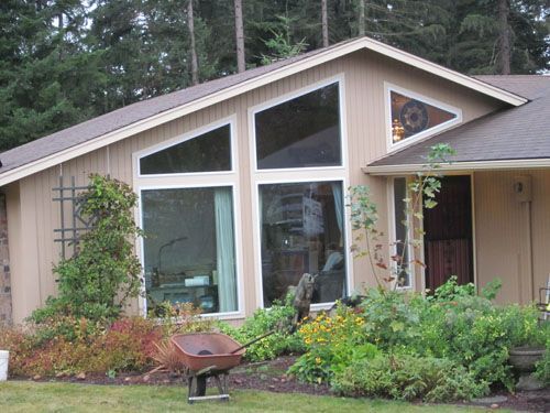 A house with a wheelbarrow in front of it