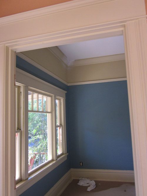 A room with blue walls and white trim