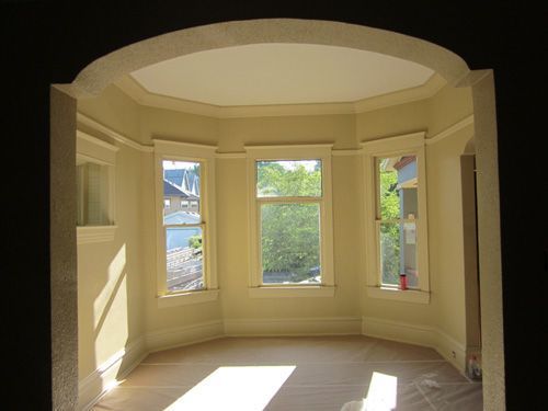 A room with a lot of windows and a black ceiling