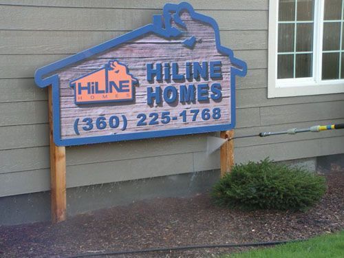 A sign on the side of a building that says hiline homes