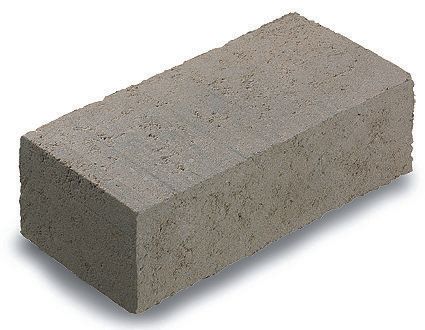 A gray brick is sitting on a white surface