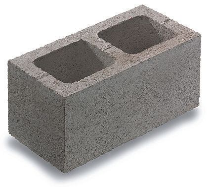 A concrete block with two holes in it on a white background