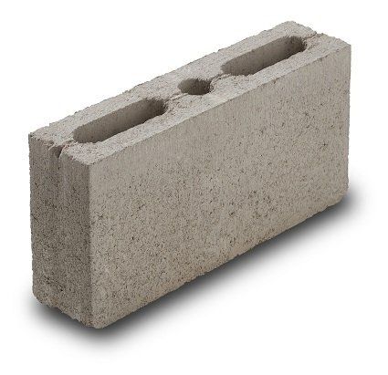 A concrete block with two holes in it on a white background