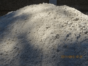 A pile of white sand is sitting on the ground.