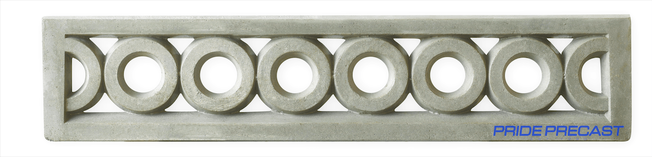 A concrete fence with a pattern of circles on it