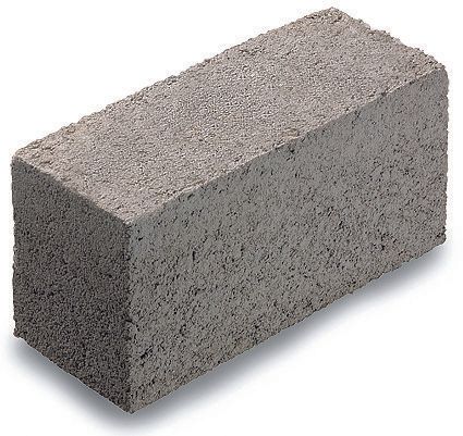 A gray brick is sitting on a white surface