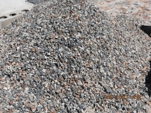 A pile of gravel is sitting on the ground.