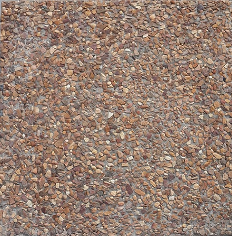 A close up of a pile of gravel on a concrete surface