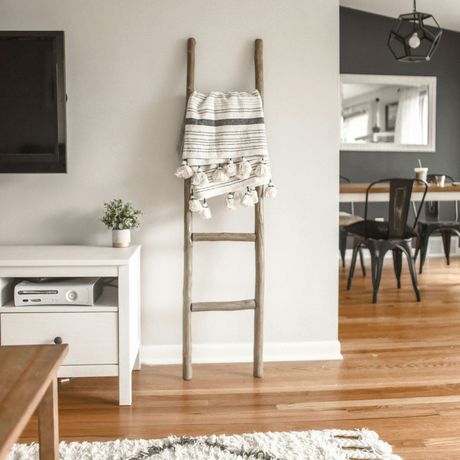 A ladder with a blanket on it in a living room