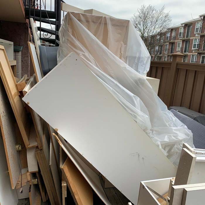 A pile of wood and plastic is stacked on top of each other. - debris cleanup