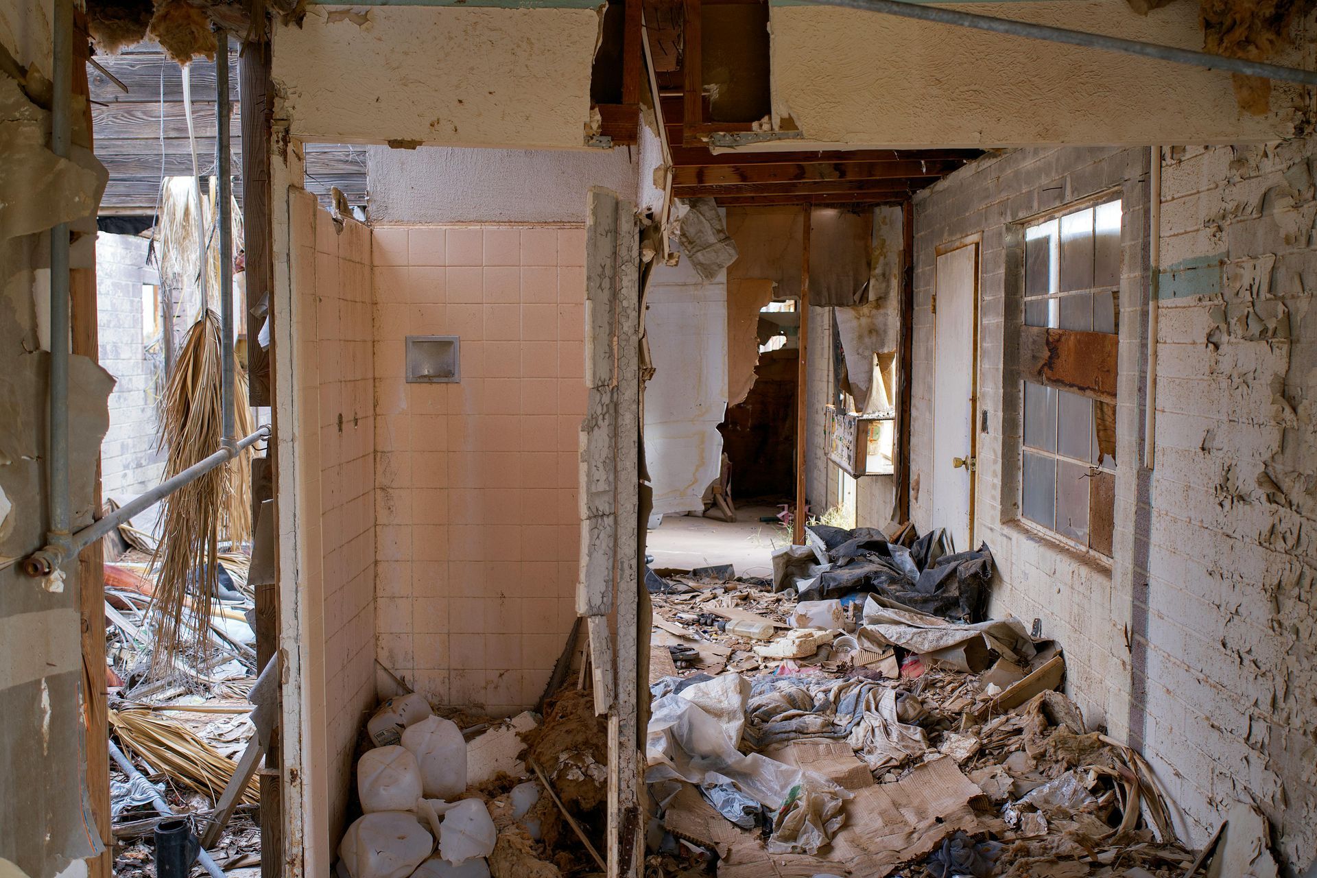 The inside of an abandoned building with a lot of trash on the floor - interior demolition massapequa ny