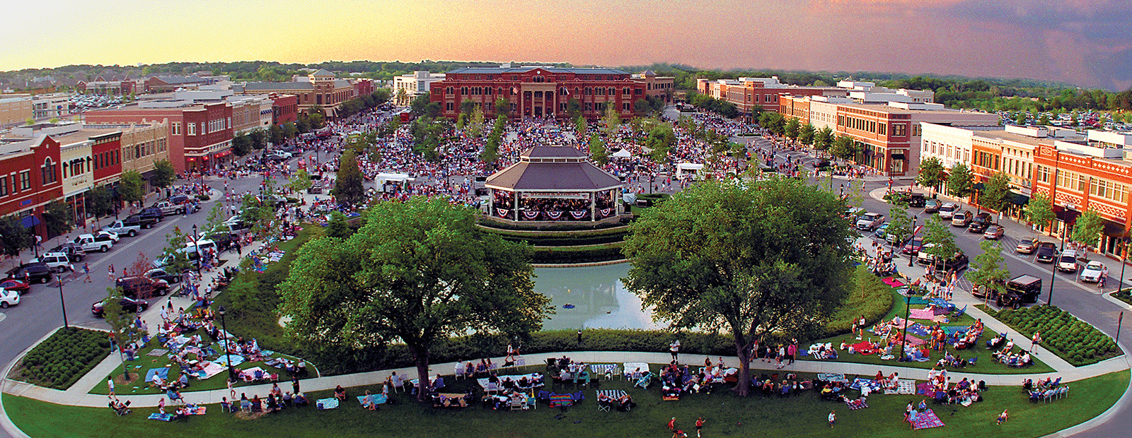 Aerial view of a bustling community event with custom homes in Southlake, Texas, during twilight.