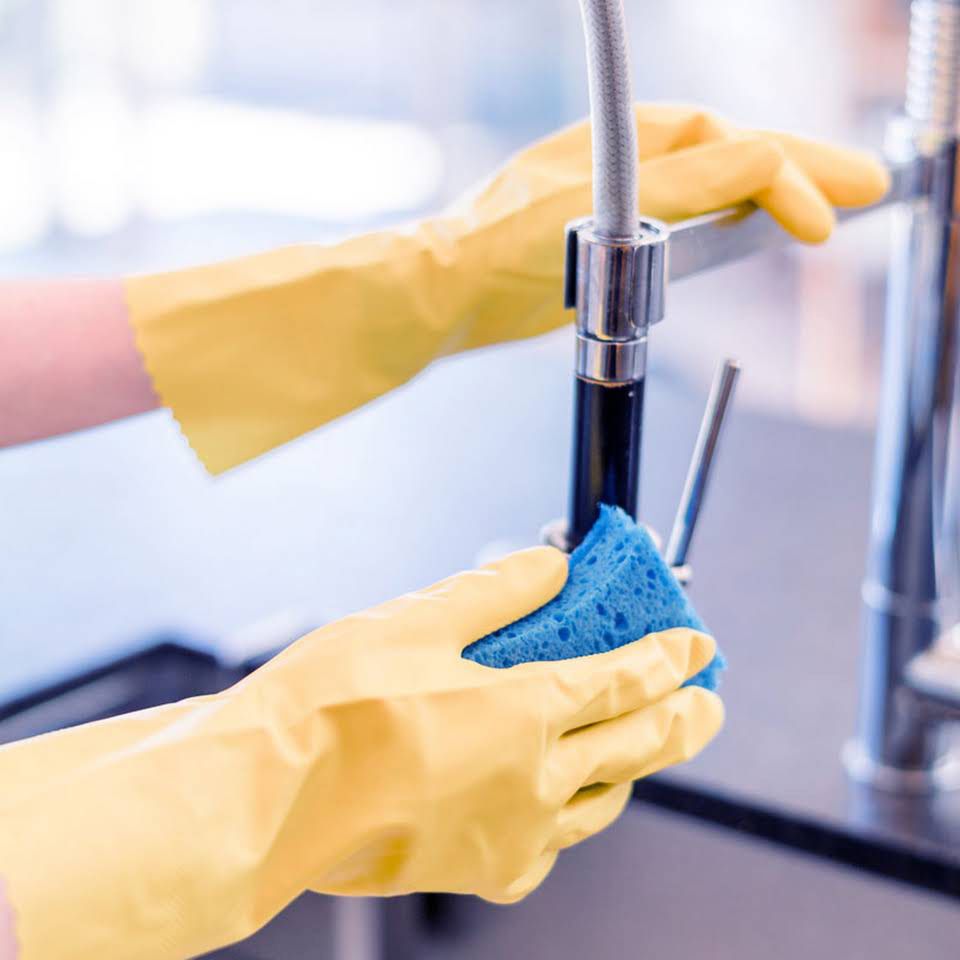 A Person Wearing Yellow Gloves Is Holding a Blue Sponge — North Coast Commercial Cleaners In Noosa, QLD