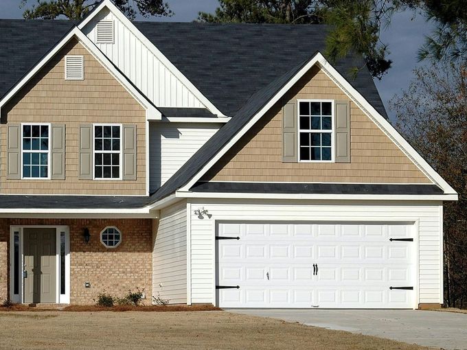 A large brick house with a white garage door