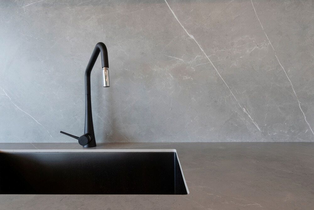 A Black Sink With a Black Faucet in a Kitchen — Corrimal Ceramic Tiles Pty Ltd in Corrimal, NSW