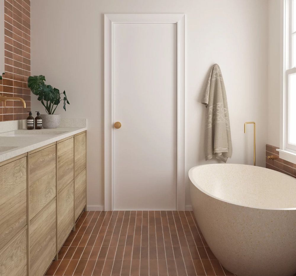 A Bathroom With A Bathtub And A Sink — Corrimal Ceramic Tiles Pty Ltd in Corrimal, NSW