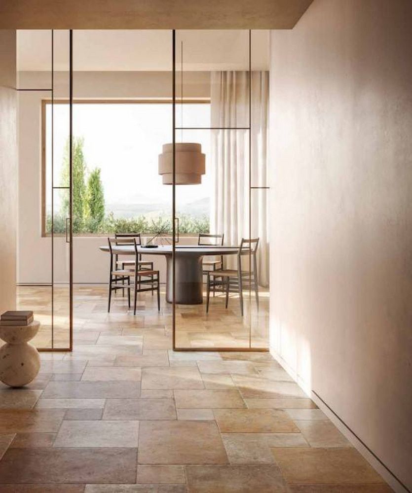 A Dining Room With A Table And Chairs And A Sliding Glass Door — Corrimal Ceramic Tiles Pty Ltd in Corrimal, NSW