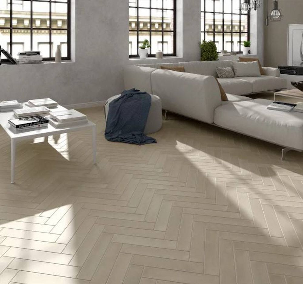 A Living Room With A Couch, Coffee Table, And Windows — Corrimal Ceramic Tiles Pty Ltd in Moss Vale, NSW