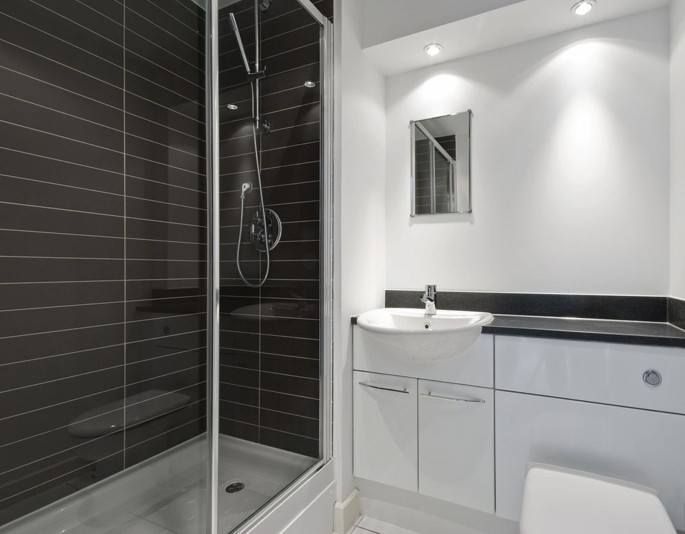 A Bathroom With A Shower, Sink, Toilet And Mirror — Corrimal Ceramic Tiles Pty Ltd in Thirroul, NSW