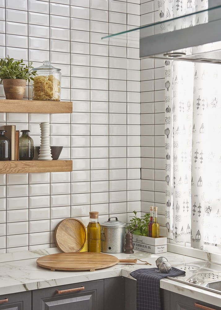 A Kitchen With White Tiles, Wooden Shelves, A Sink, And A Window — Corrimal Ceramic Tiles Pty Ltd in Mittagong, NSW