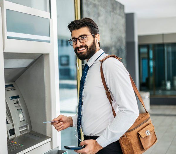 Happy Man in Front of ATM Machine