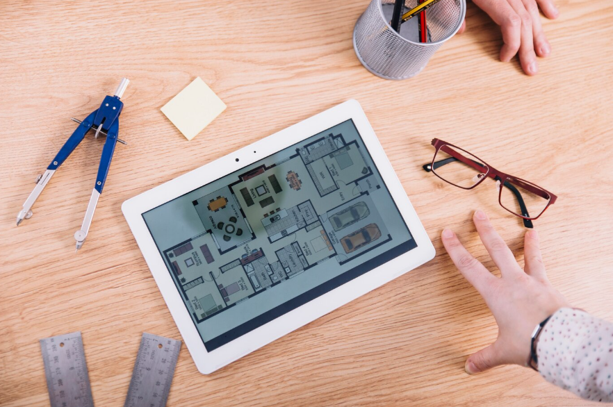 hands near tablet with plan