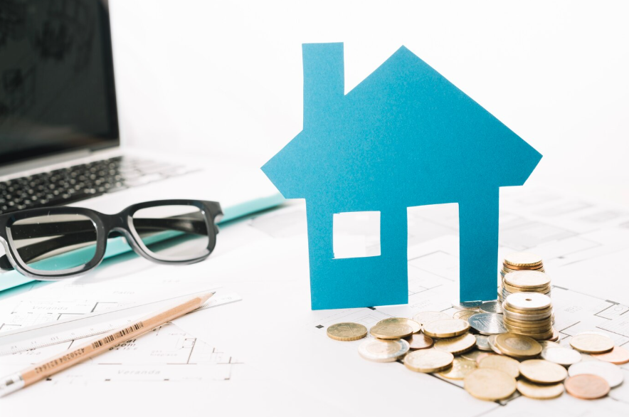 a small house figurine and coins