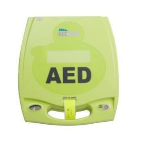 A green aed device is sitting on a white surface.