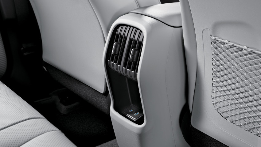 A black and white photo of the back seat of a car. hyundai kona hybrid