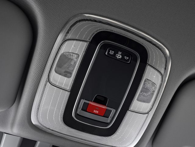 A car ceiling light with a red button that says ' emergency ' on it