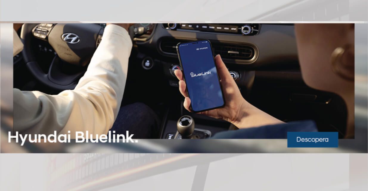 A person is holding a cell phone in their hand in a car.