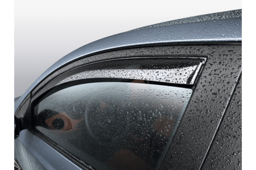 A close up of a car window with rain drops on it