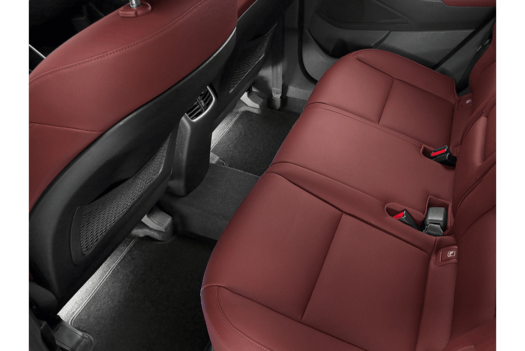 The back seat of a car with red leather seats