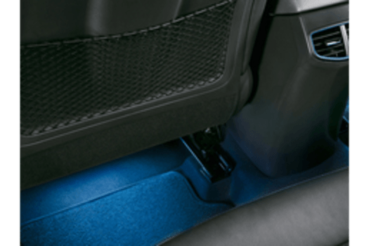 The back seat of a car has a blue mat underneath it