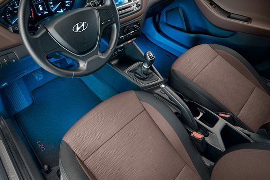 The interior of a hyundai car with blue lights on the floor