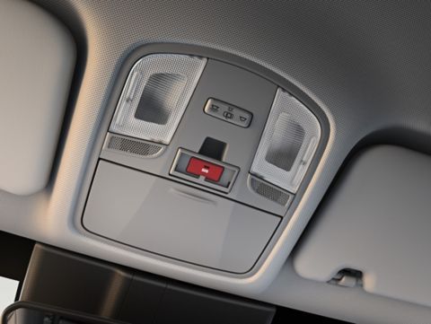 The ceiling of a car with a red button on it. Kona Hibrid
