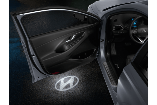 A car with the door open and a hyundai logo on the door