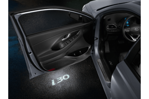 A car with the door open and a light on the door that says i30